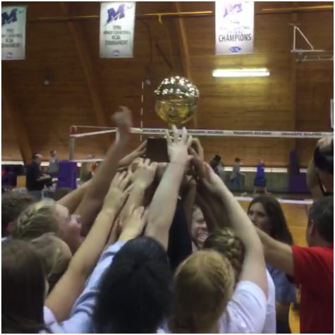 The OHS Volleyball team hoists the golden ball after winning the MHSAA Class II State Championship.