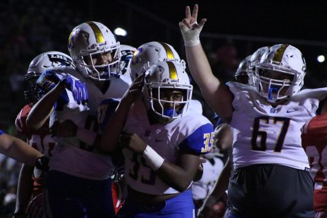 Senior Kalin Brown celebrates with his teammates after scoring a touchdown.