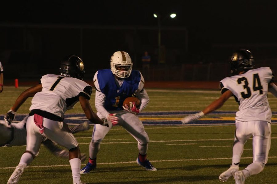 Hiram Wadlington runs the ball against the Trojan defense. The Chargers went on to beat the Trojans 31-13 in Friday nights Homecoming game.