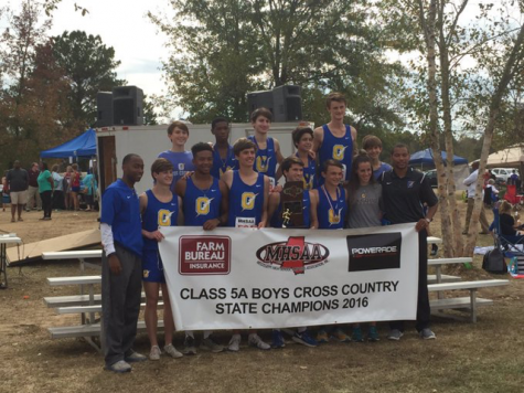The OHS boys cross country team poses for a picture after winning the MHSAA Class 5A State Championship.