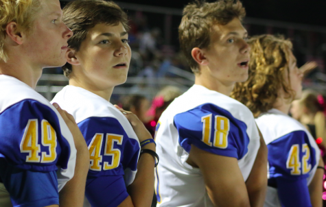 Junior Gray Jenkins, sophomore Whitman Rowland, senior Giles Lamar, and freshman Max Mobley pause for the national anthem.