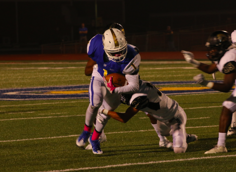 Junior running back Hiram Wadlington tries to elude a tackle from a New Hope defender.