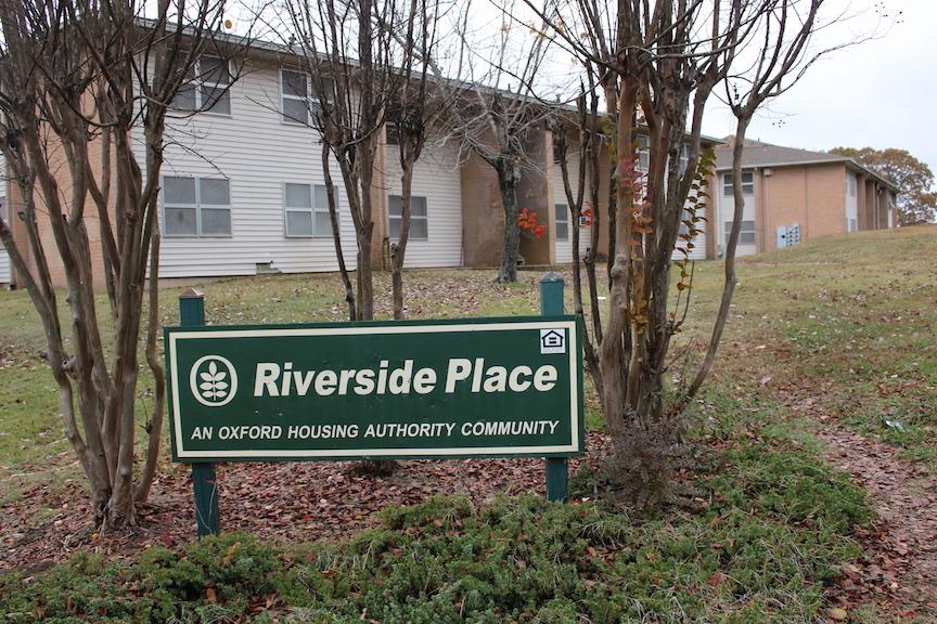 The Riverside Place sign stands in front of one of many apartment buildings of the neighborhood. The public housing complex will close in February. 