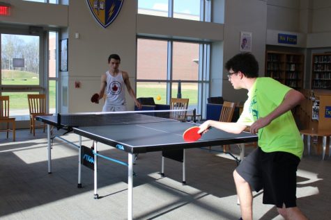 Senior Kyle Rock (left) and junior Bennett Brown (right) compete in the final round of the table tennis tournament held on March 28 to determine who would be the first place winner.