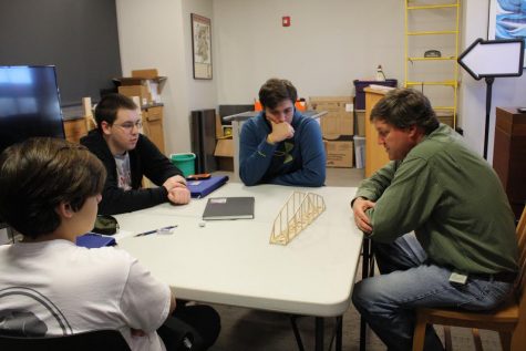 Civil Engineer for MDOT David Evans III helps members of the engineering club with their bridge.