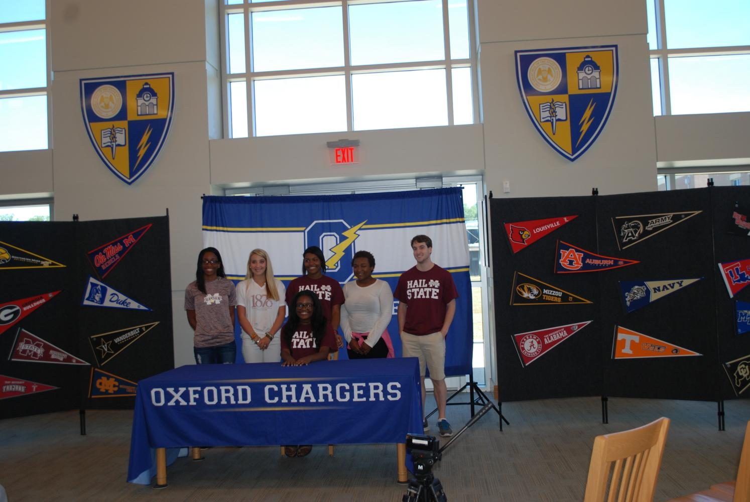 Seniors gather for a photograph after senior signing day in the library.