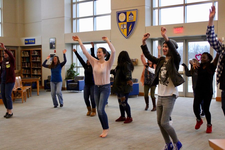 sophomores Sophie Quinn and Jupiter O’Donnell do the warmup dance at Moving Metaphors. The event was held on Feb. 6 in the library. 