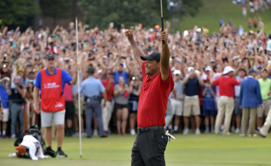Tiger+Woods+raises+his+hands+in+triumph+after+shooting+his+final+hole.+This+weekend%2C+Woods+won+the+PGA+Tour+Championship+for+the+first+time+since+2013.