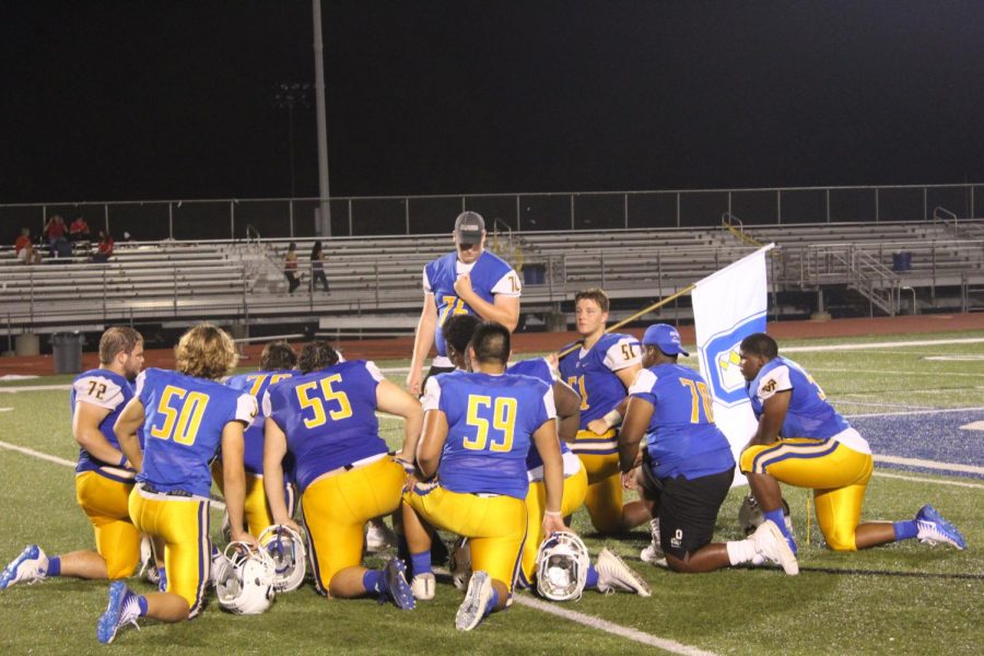 The Oxford Chargers football team talks in a circle after a game last year. Tupelo won last years meeting with a score of 34-8. 