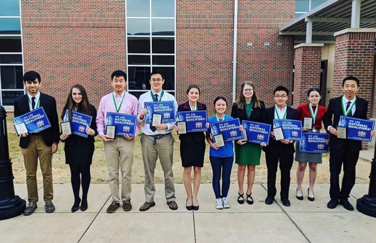 The winners of the National  Qualifying tournament smile and pose with their awards. OHS hosted the National Qualifying tournament on March 22-23.