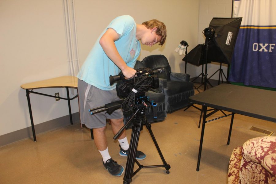 Senior Dalton Whitehead sets up a camera and gets ready to film a segment for Charger Nation Productions. Charger Nation Productions will be released monthly.  