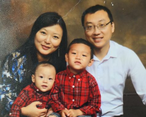 Chinese teacher Xin Shi smiles and poses with her two children and husband. Shi teaches Chinese at Oxford High School. 