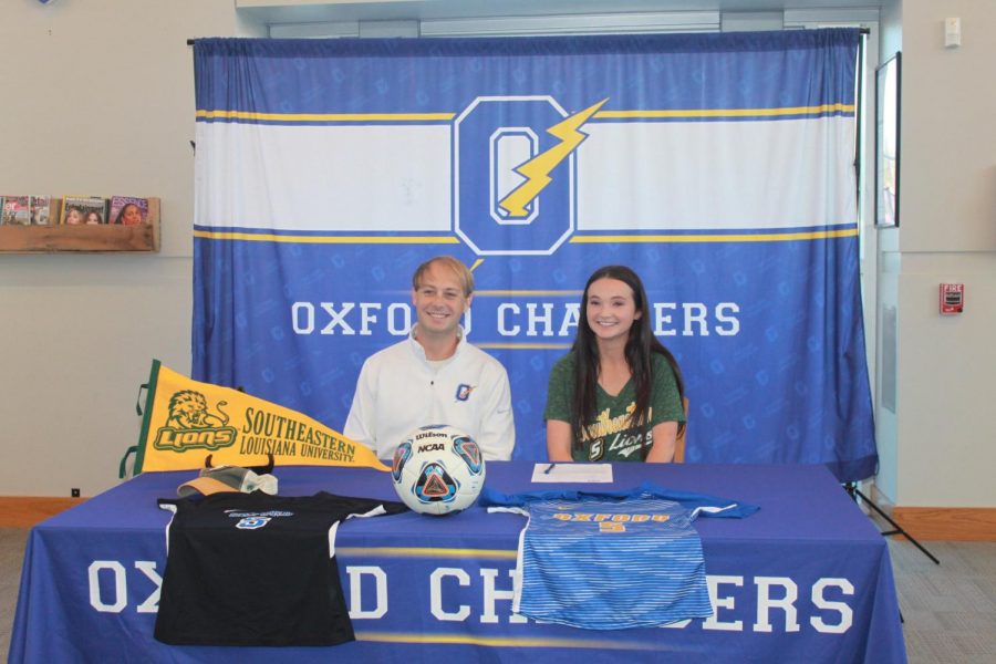 Senior Kathleen Myers smiles with her head soccer coach Hunter Crane on College Signing Day. Myers has committed to Southeastern Louisiana to further her soccer career.