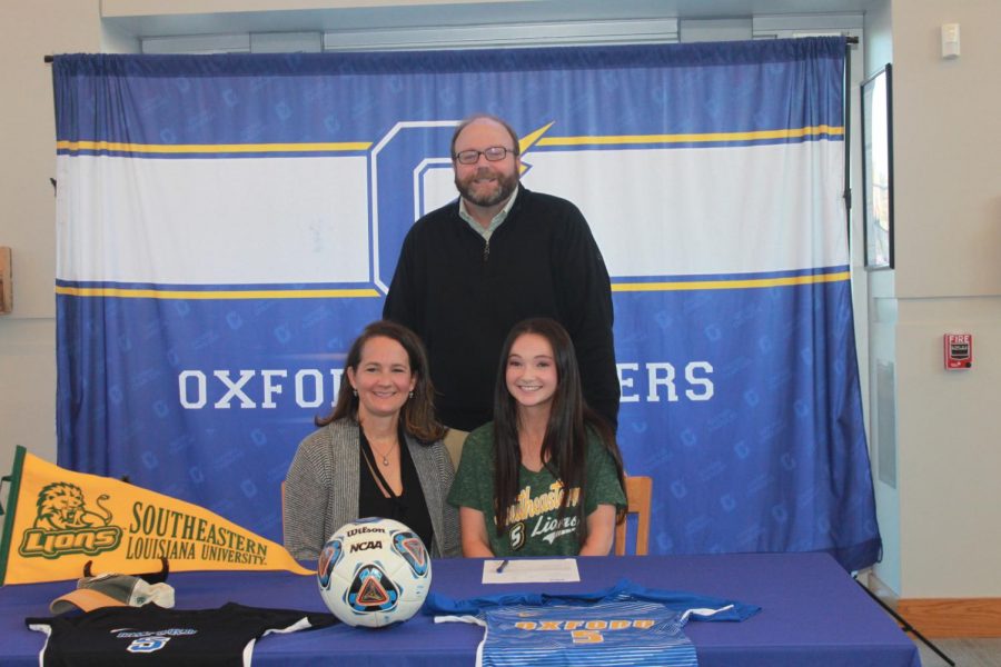 Senior Kathleen Myers smiles with her family on College Signing Day. Myers is currently a captain of the OHS Girls Soccer team.