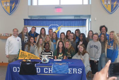 Members of the OHS Girls Soccer Team smile and stand around seniors Maria Jones and Kathleen Myers. Jones and Myers both participated in College Signing Day on Nov. 13. 