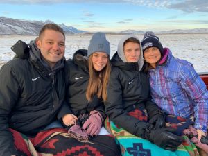 Sophomore Grace, Tatum, Brad and senior Luke Freeman pose for a family picture in Wyoming during the holidays. The Freeman family has a history of participating in Oxford sports programs. 