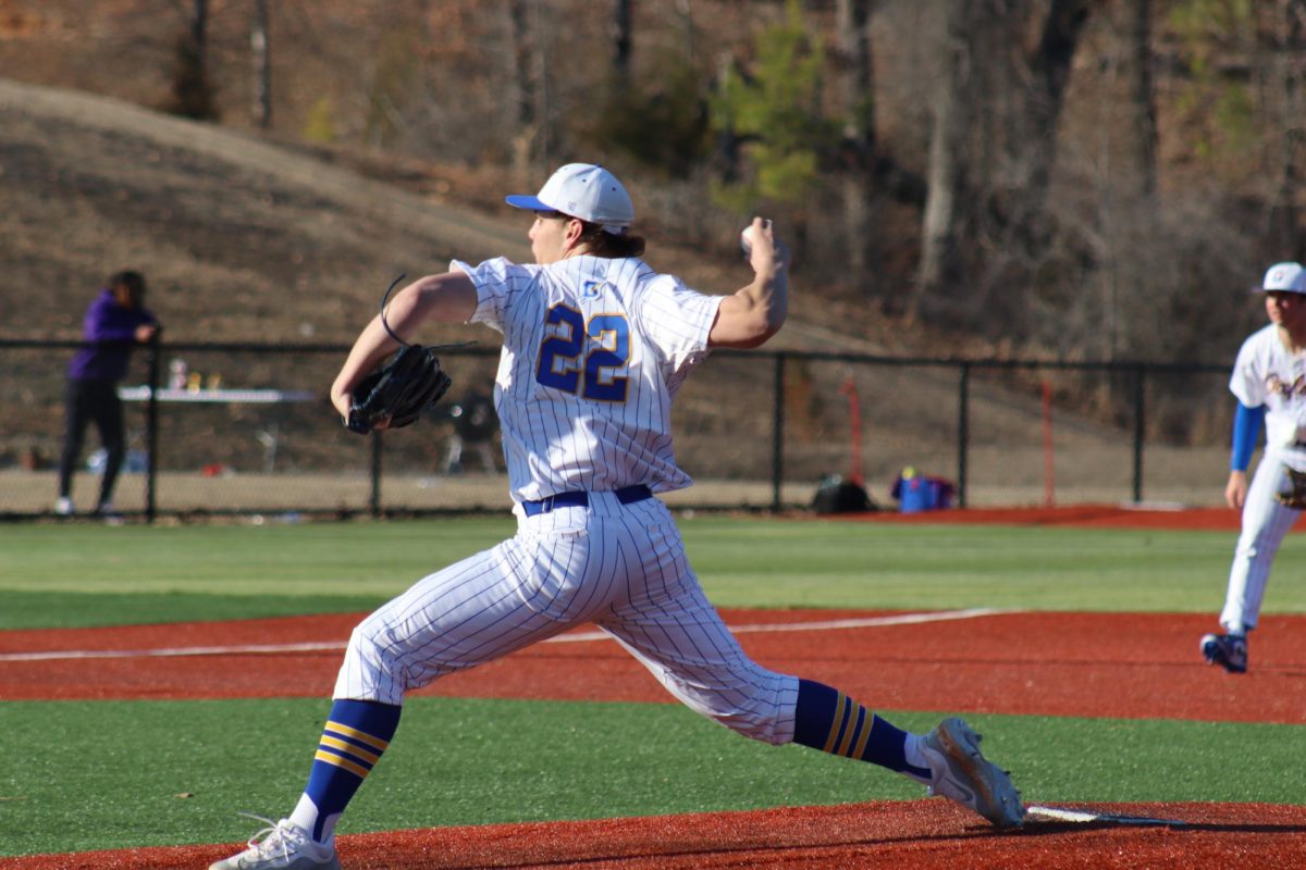 Senior Brady Stinnett pitches the ball in their game against Grenada. The Chargers won the game 8-2.