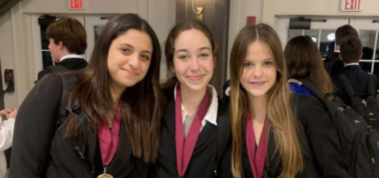 Renad Radwan, sophomore, with freshmen Eleanor King
and Lilly Schornhorst, sophomore, pose for a picture after competing in a tournament. All three girls placed as semifinalists in public forum debate at this event.