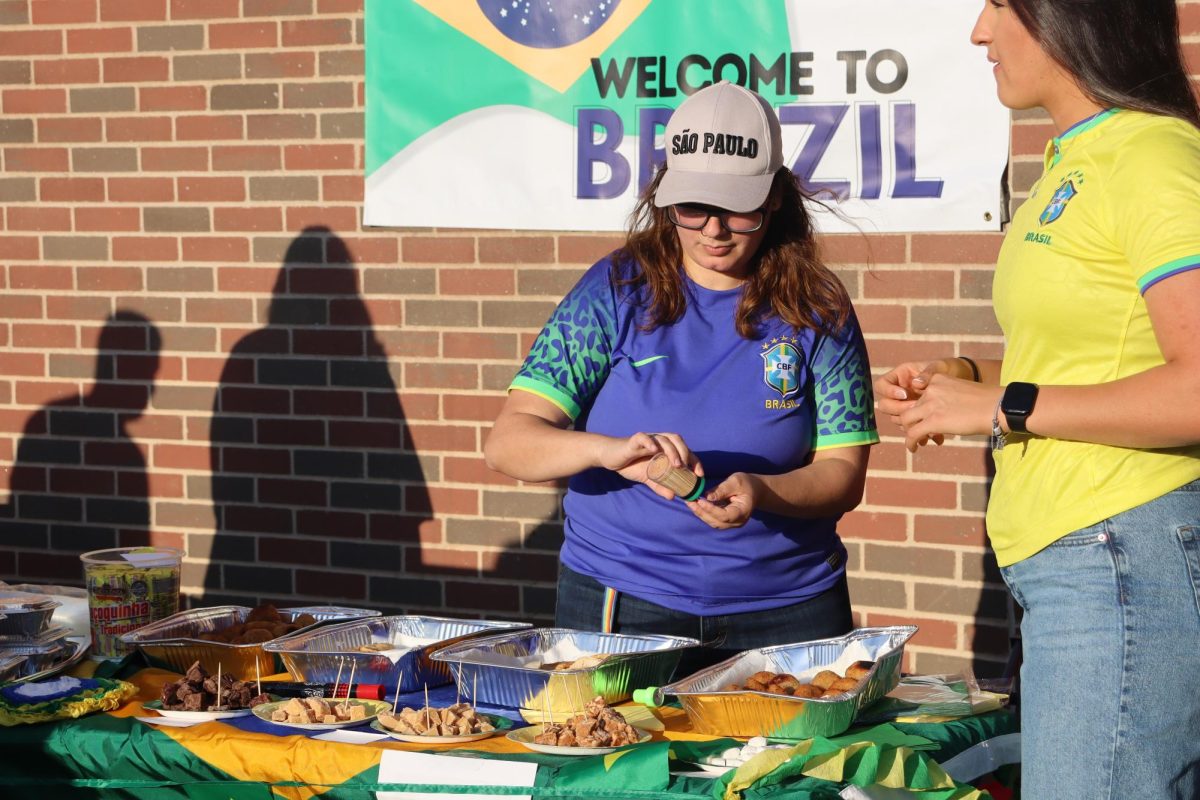 Lady at the Brazil station places toothpicks in authentic Brazilian food. Brazil was one of many countries set up at the Festival of Nations.